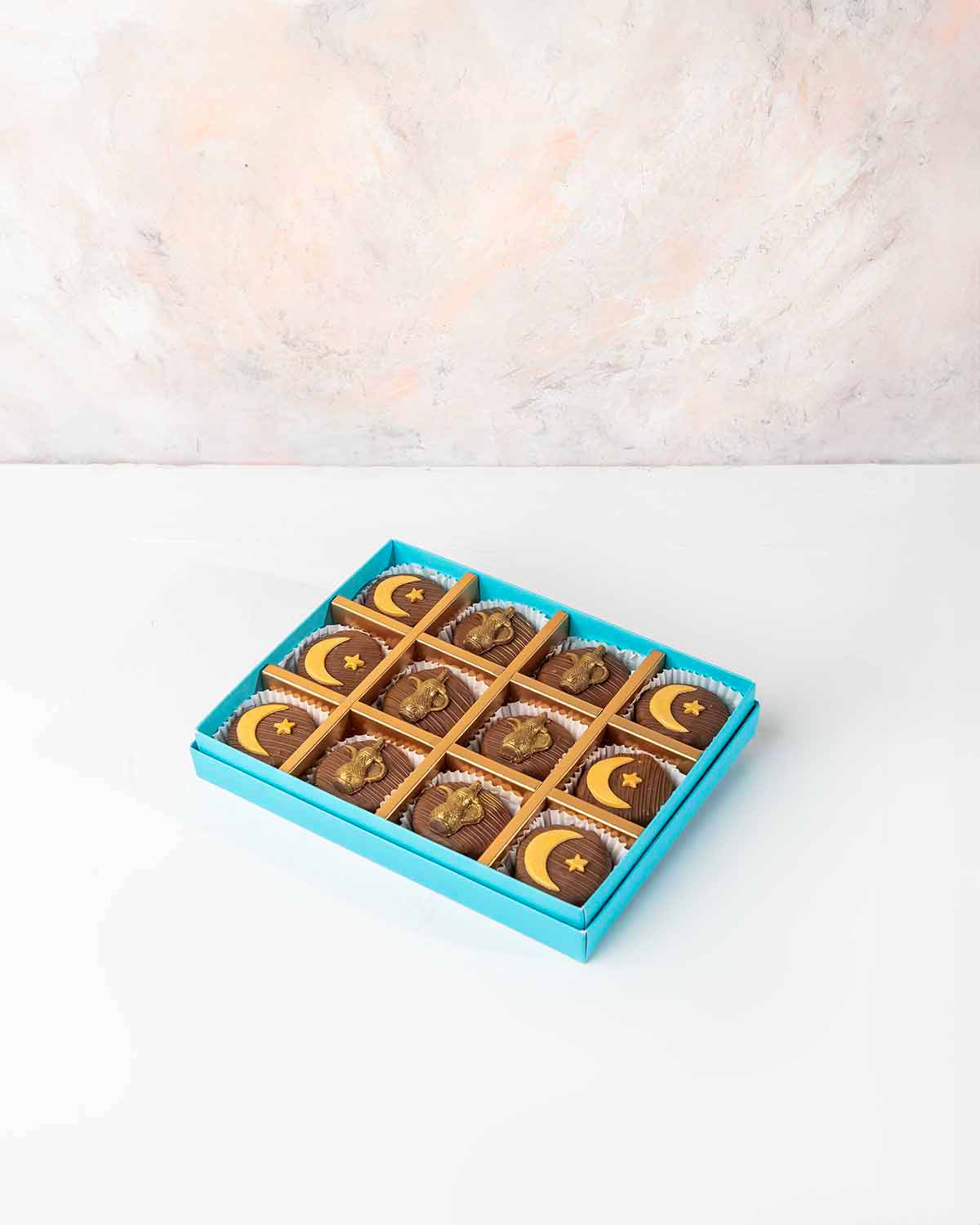 Ramadan Theme Chocolate covered Cake bites by NJDChocolate & ConfectioneryYour Gift Contains:• 12 x Ramadan theme Milk chocolate covered cake bites• Cake Flavors: Chocolate/Vanilla/Red Velvet• Box Size: 24x18x4cmHandling and Storage • Keep away from direc